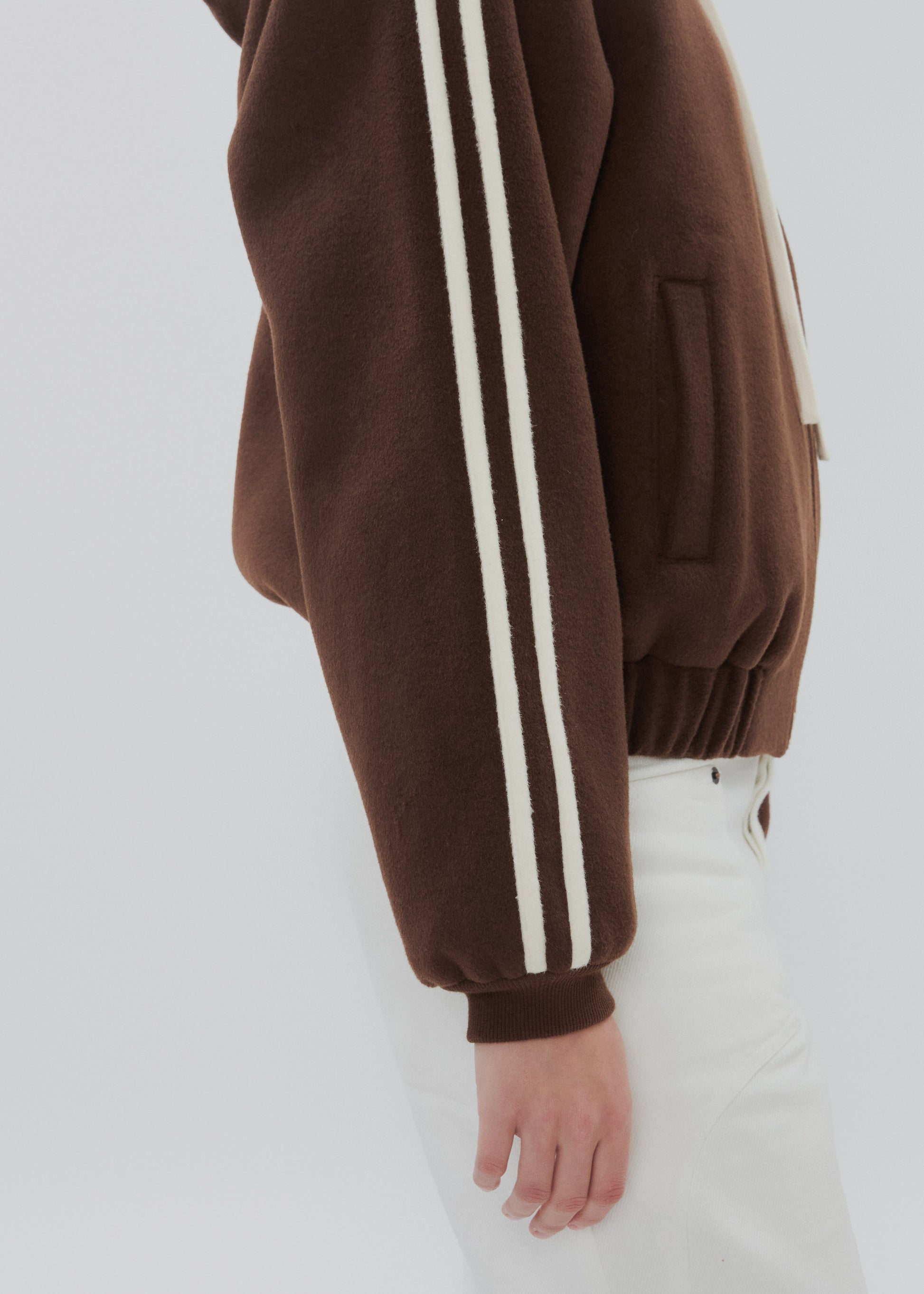 Brown sweatshirt with white stripes on a plain background