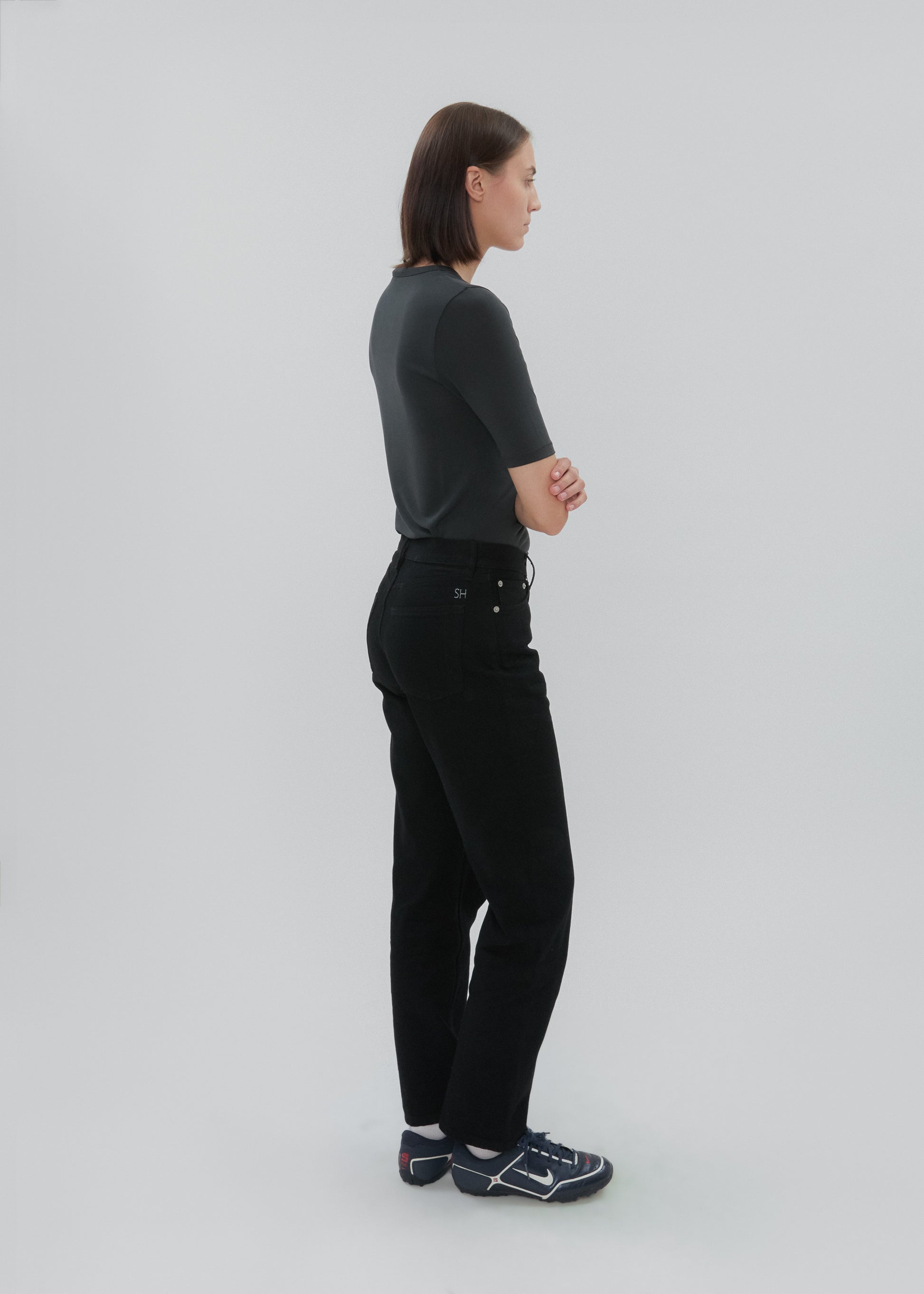 Person wearing a black outfit on a white background