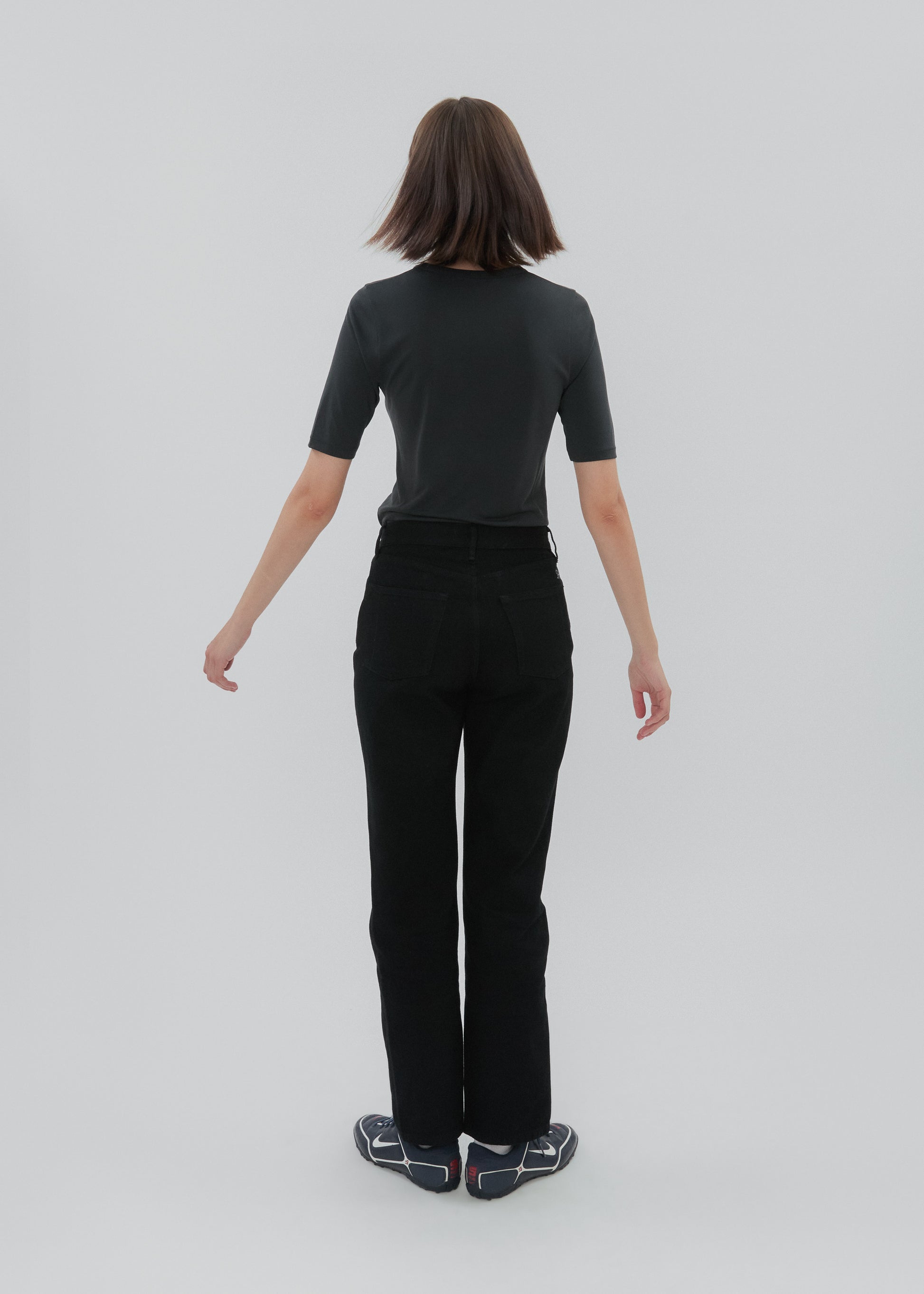 Person wearing a black outfit on a white background