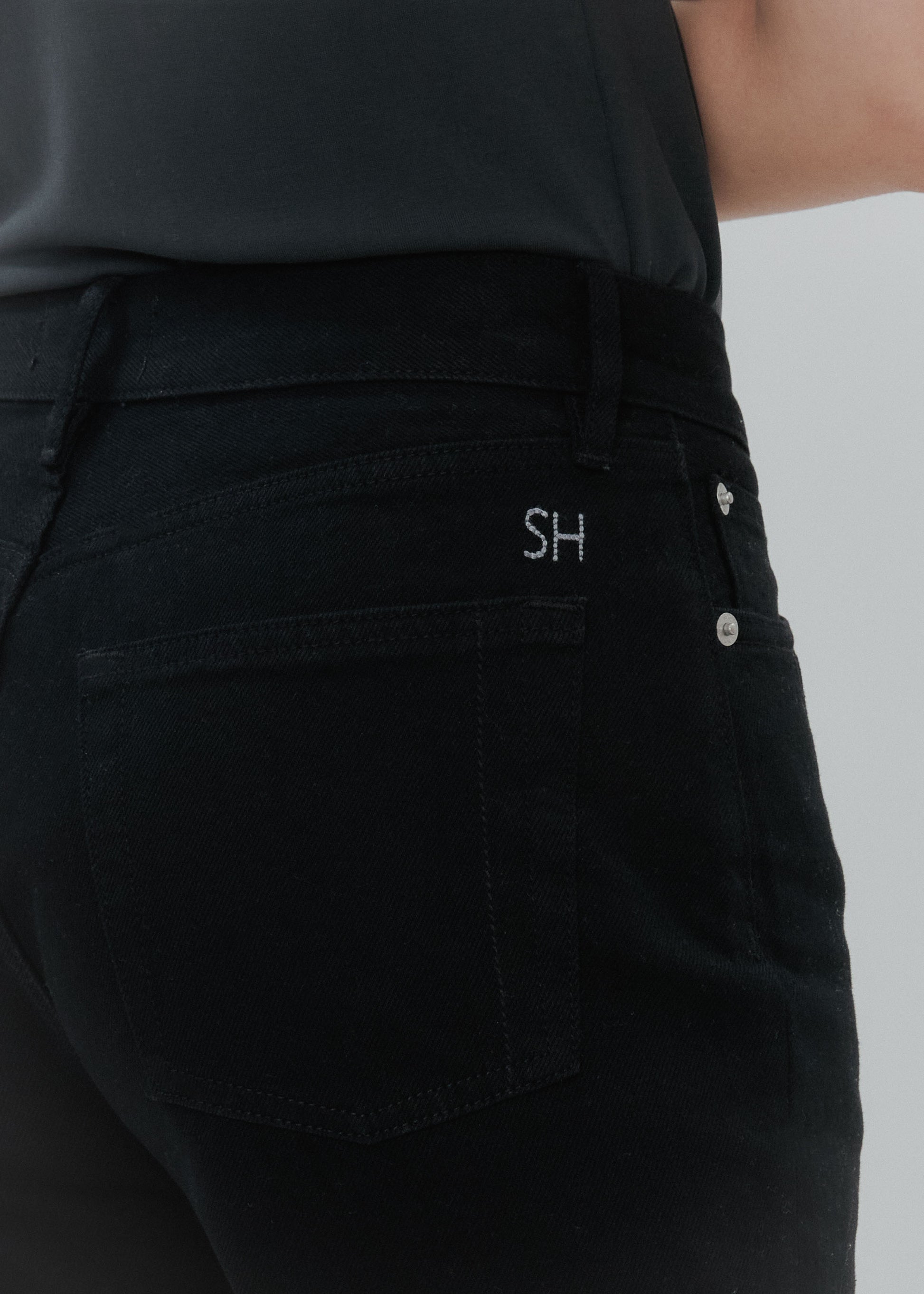 Black pants with a brand logo on a white background