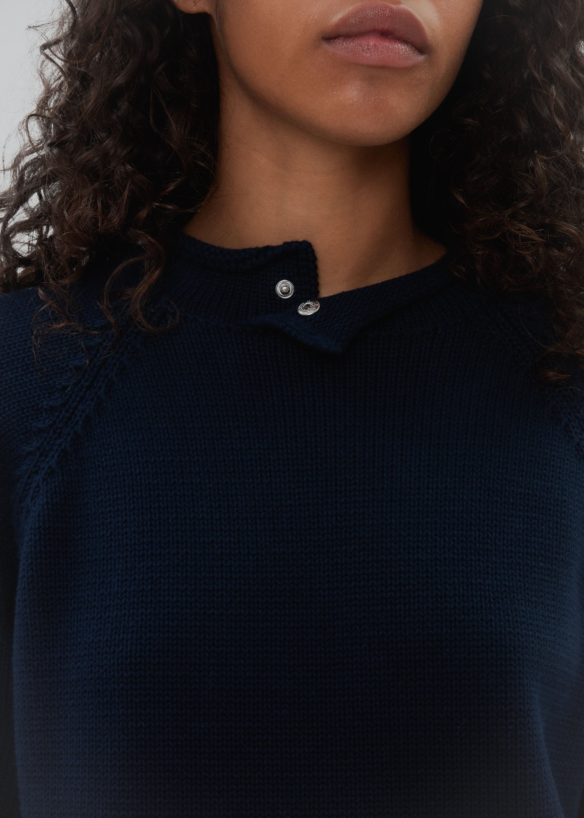 Navy blue sweater with a collar worn by a person