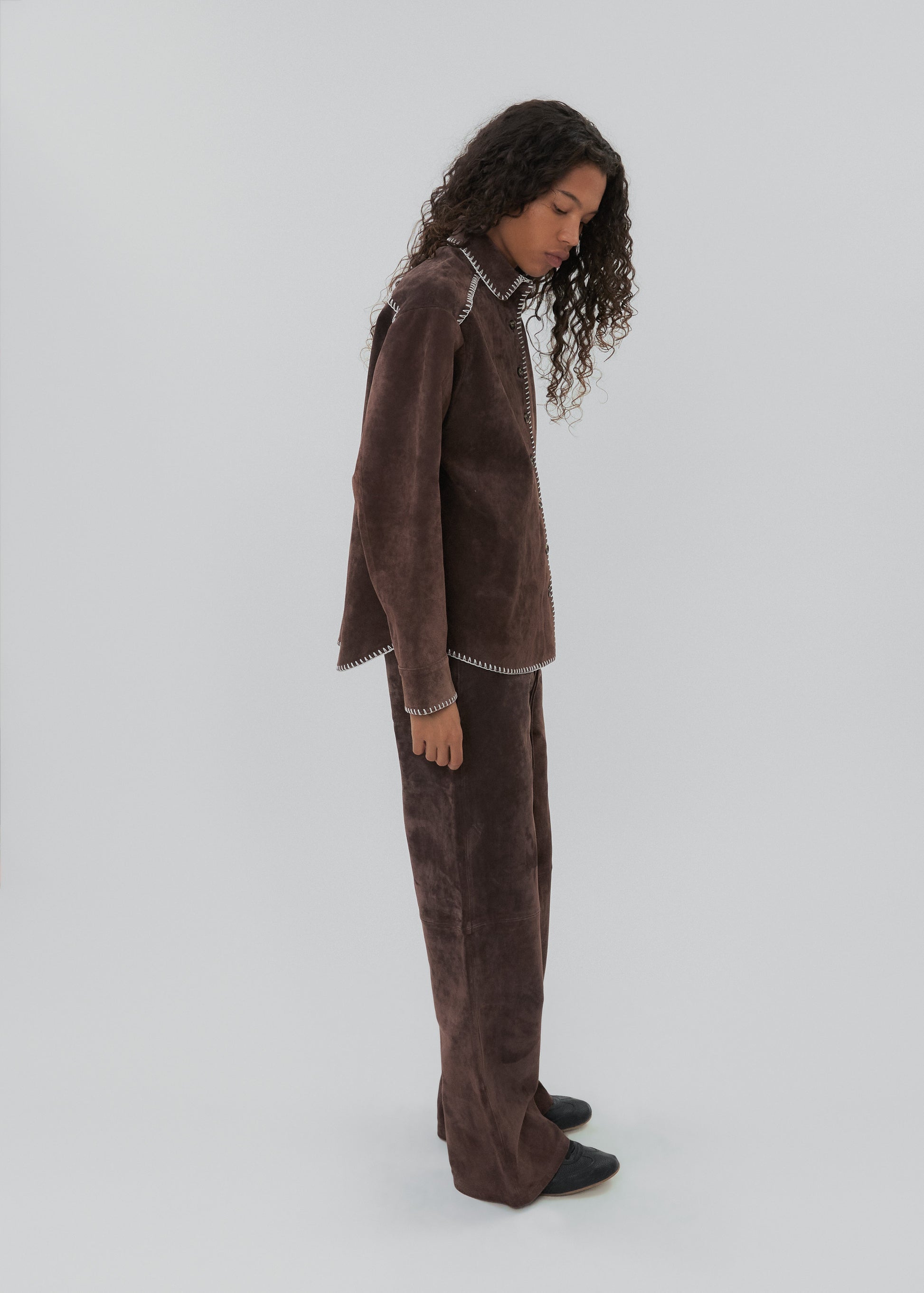 Woman wearing a brown outfit on a white background