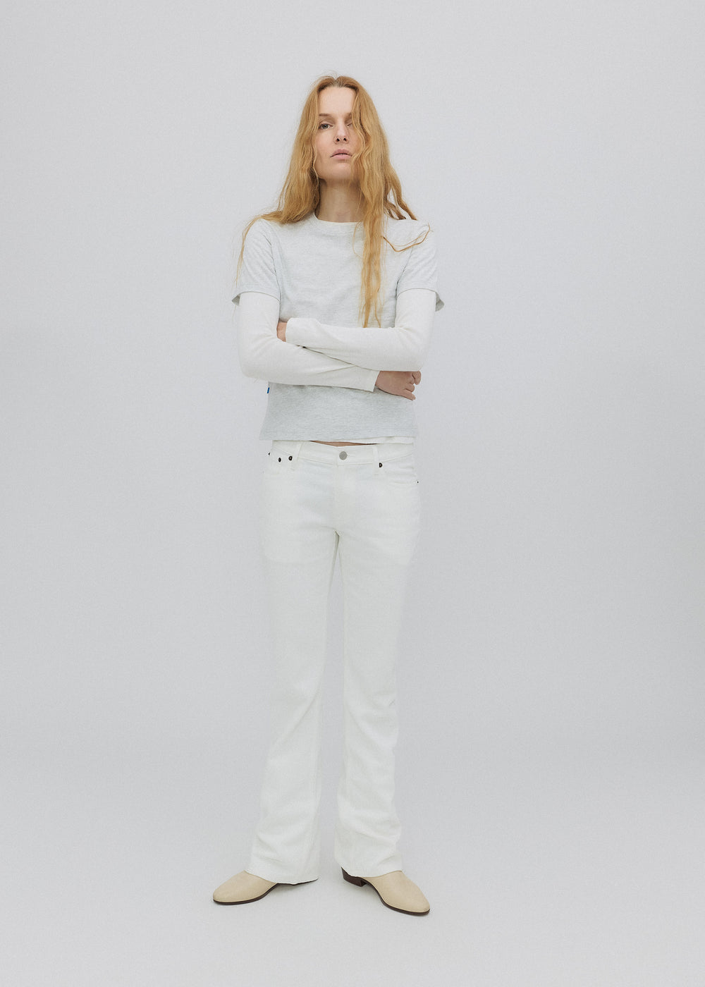 Person wearing a white outfit on a plain background