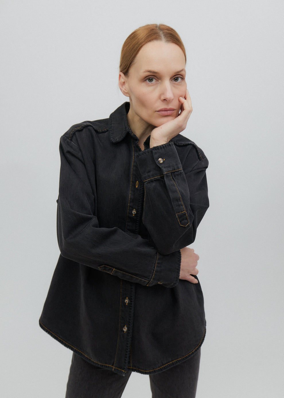 Woman wearing a black shirt against a plain background