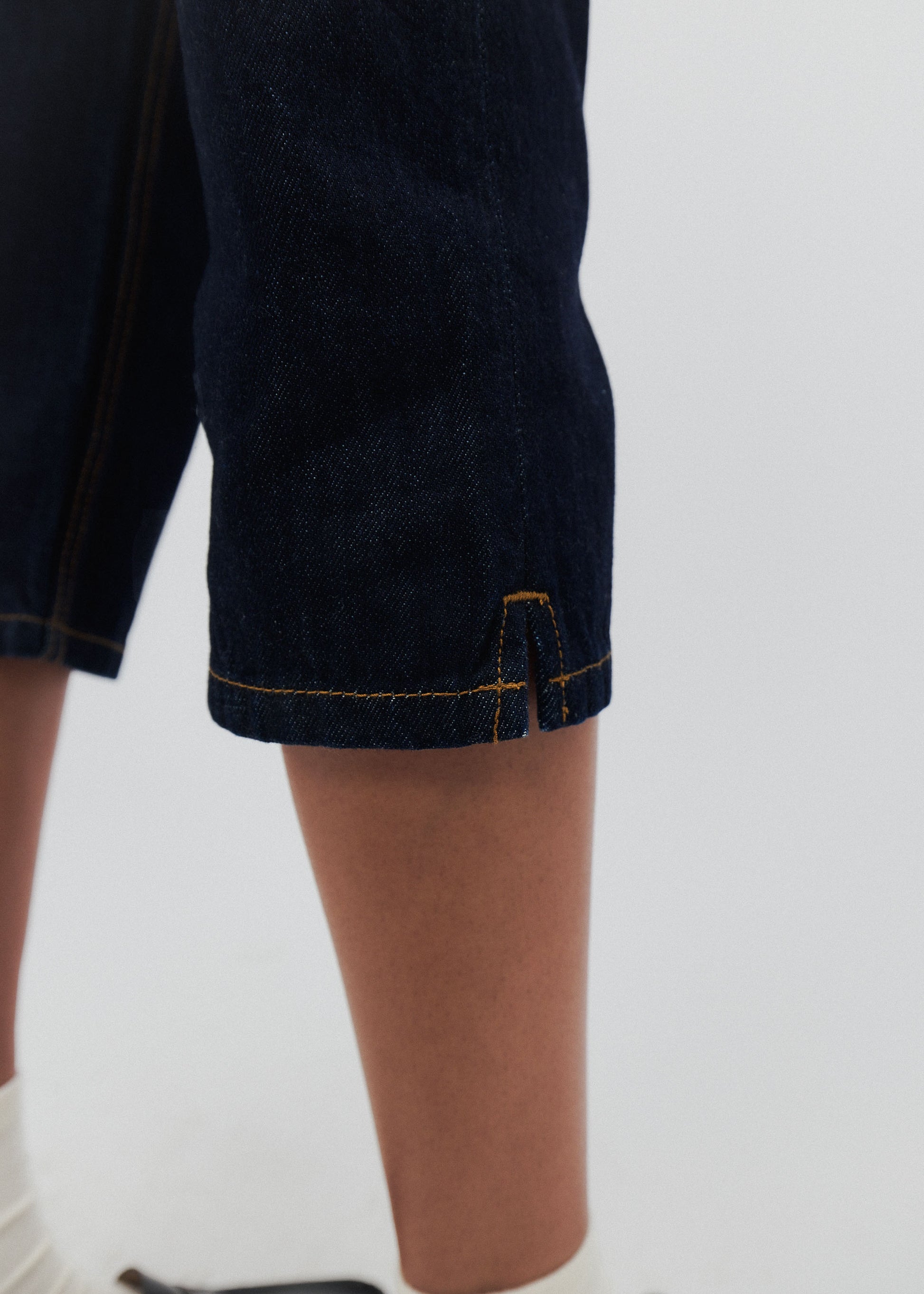 Dark blue shorts with a brand logo on a white background