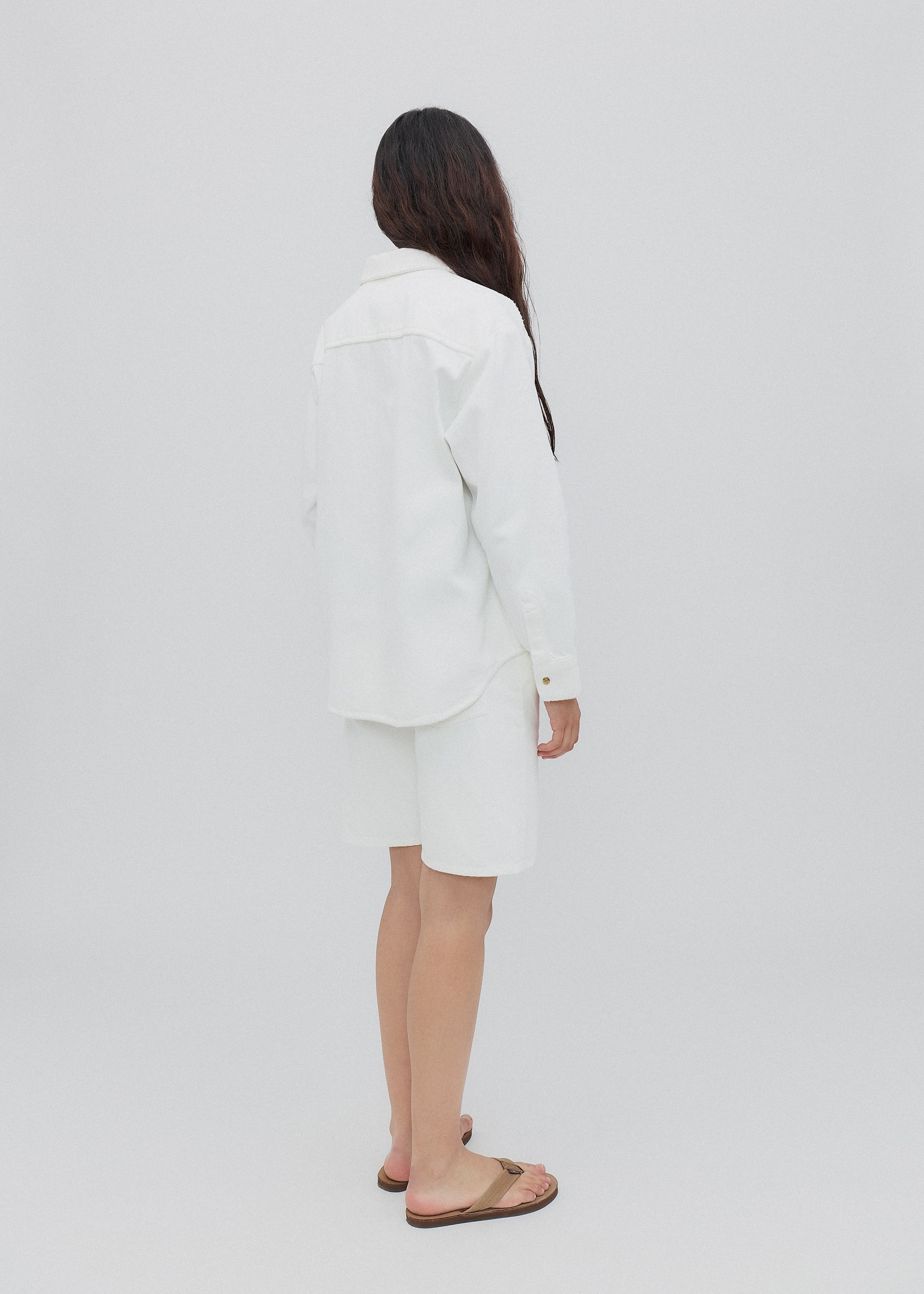 Person wearing a white outfit on a plain background