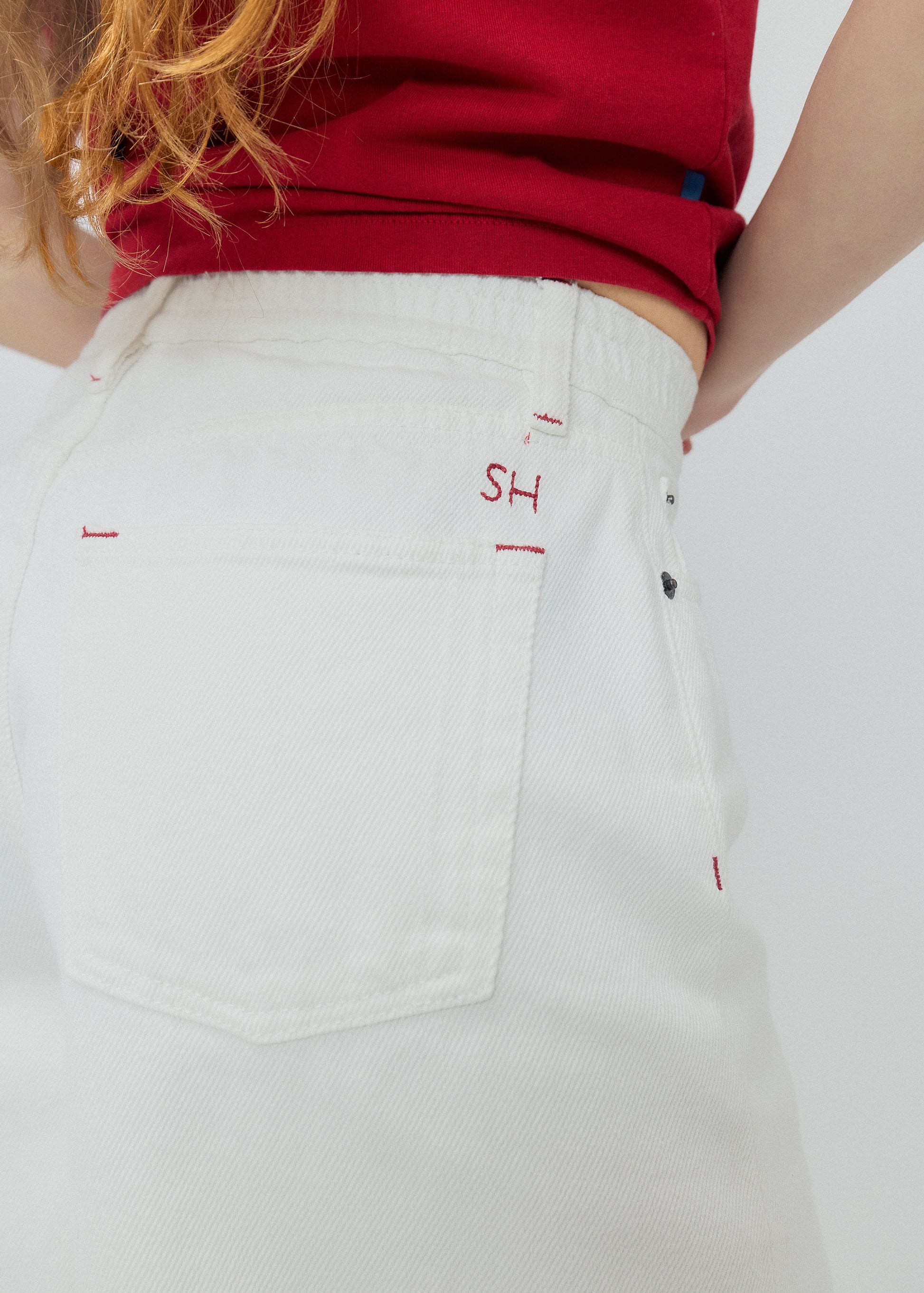 White pants with red text on a white background