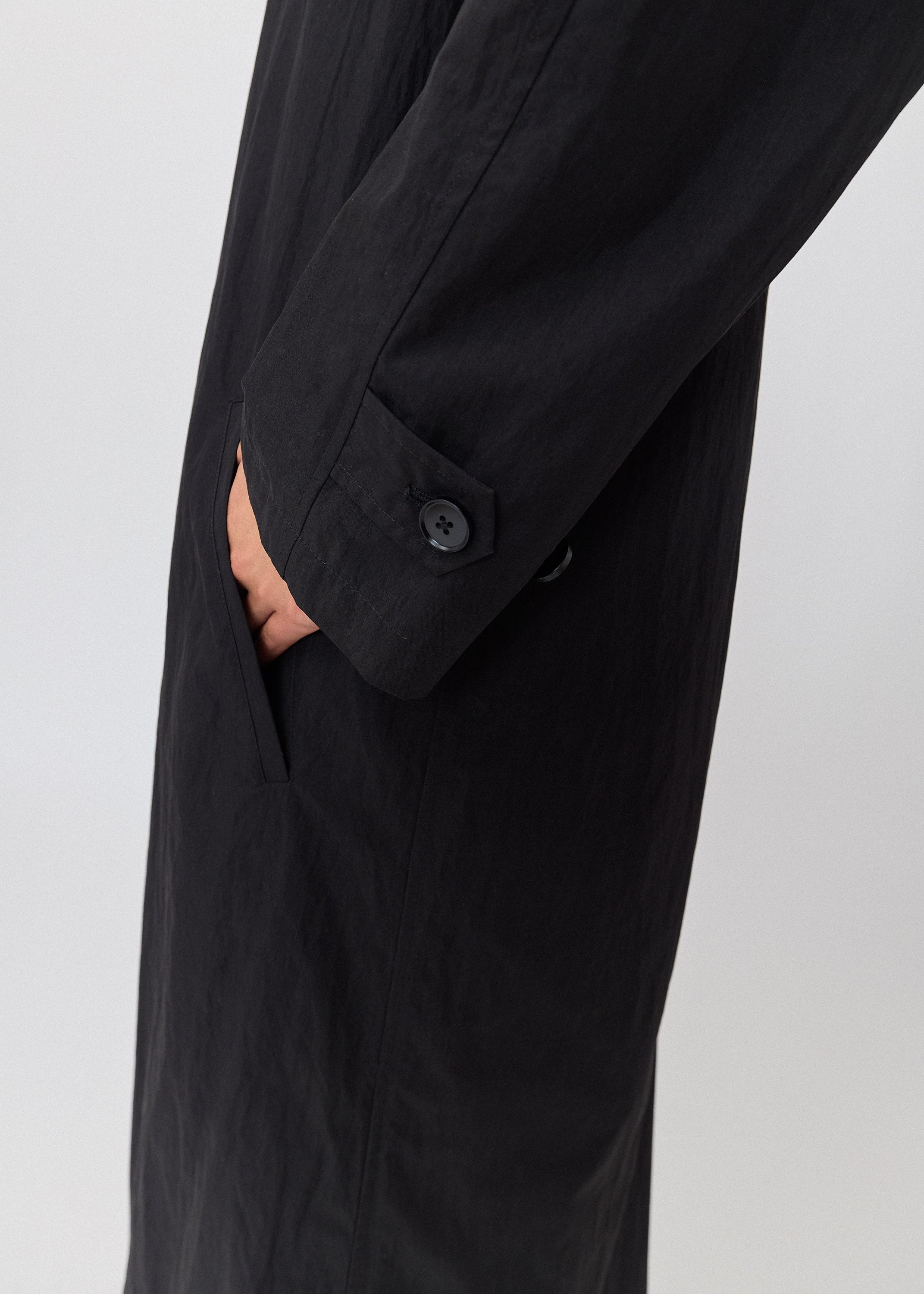 Black coat with a button on a white background
