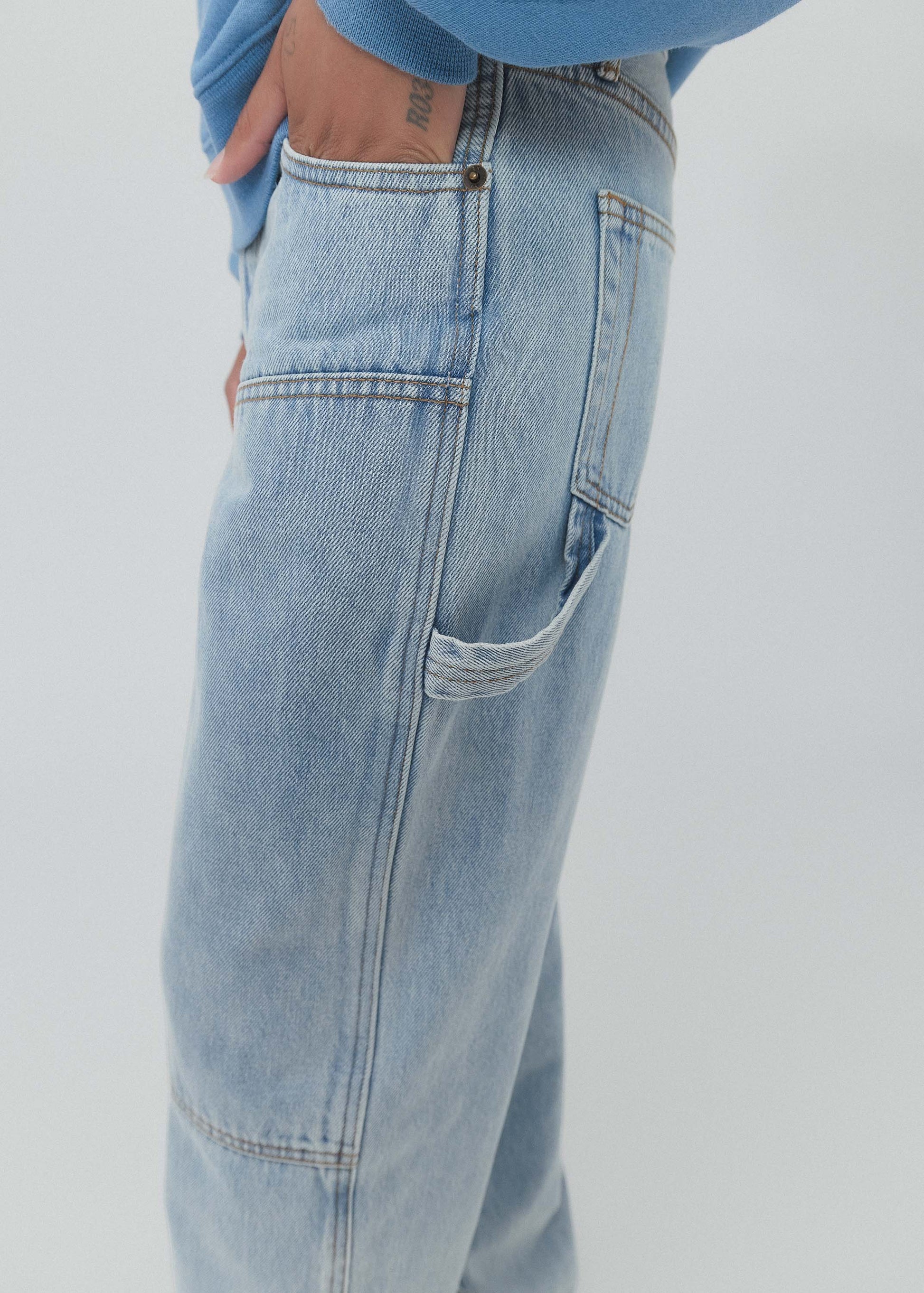 Light blue jeans worn by a person on a white background