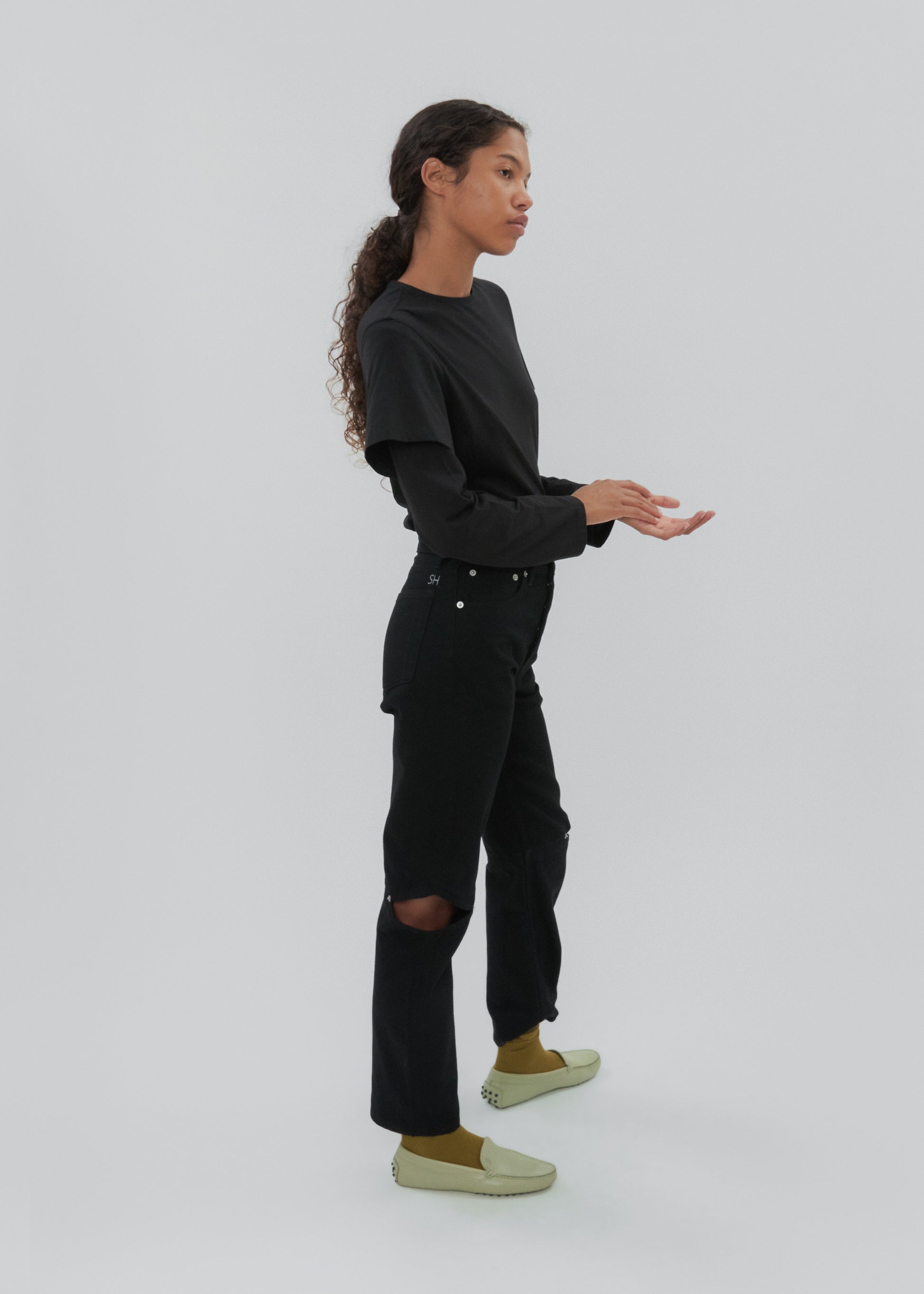 Person wearing a black outfit with a white background