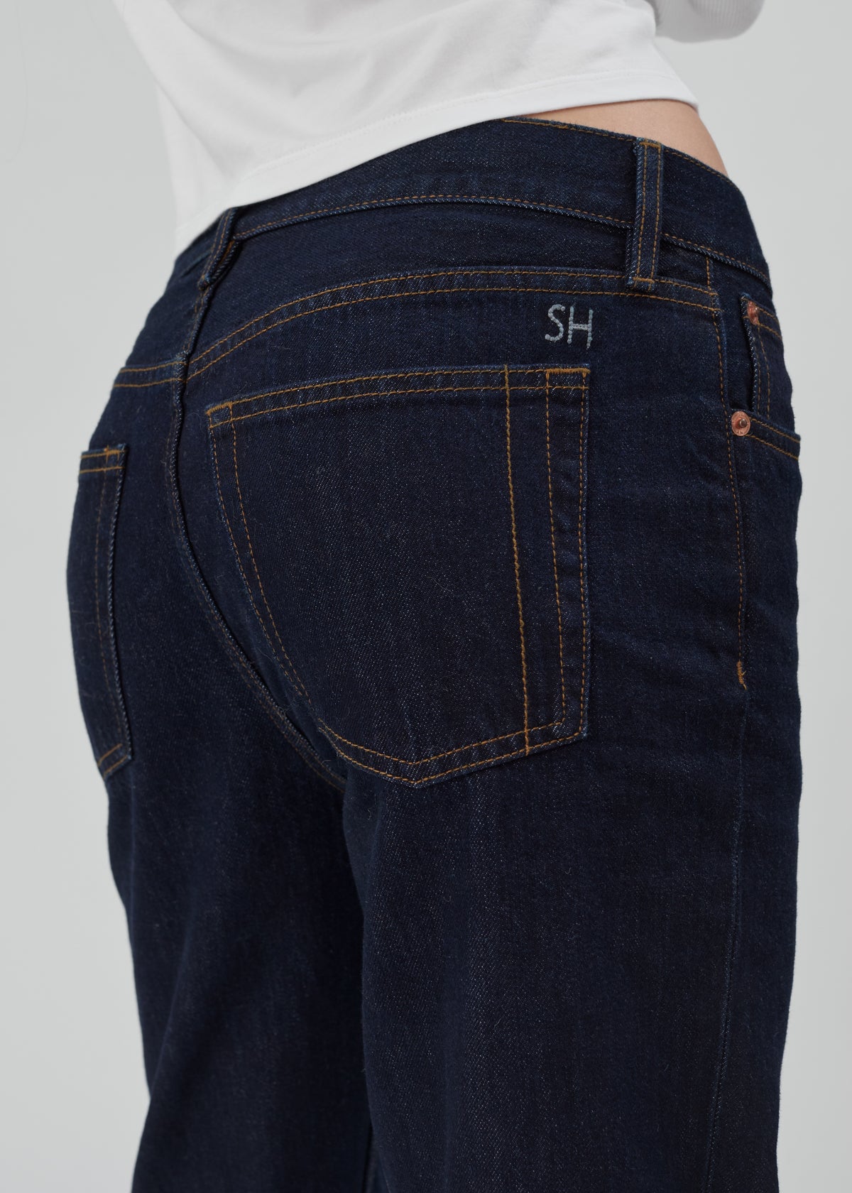 Life Jean in Indigo Indigo dark indigo straight-leg denim jeans with orange contrast stitching and an embroidered SH on the back pocket.