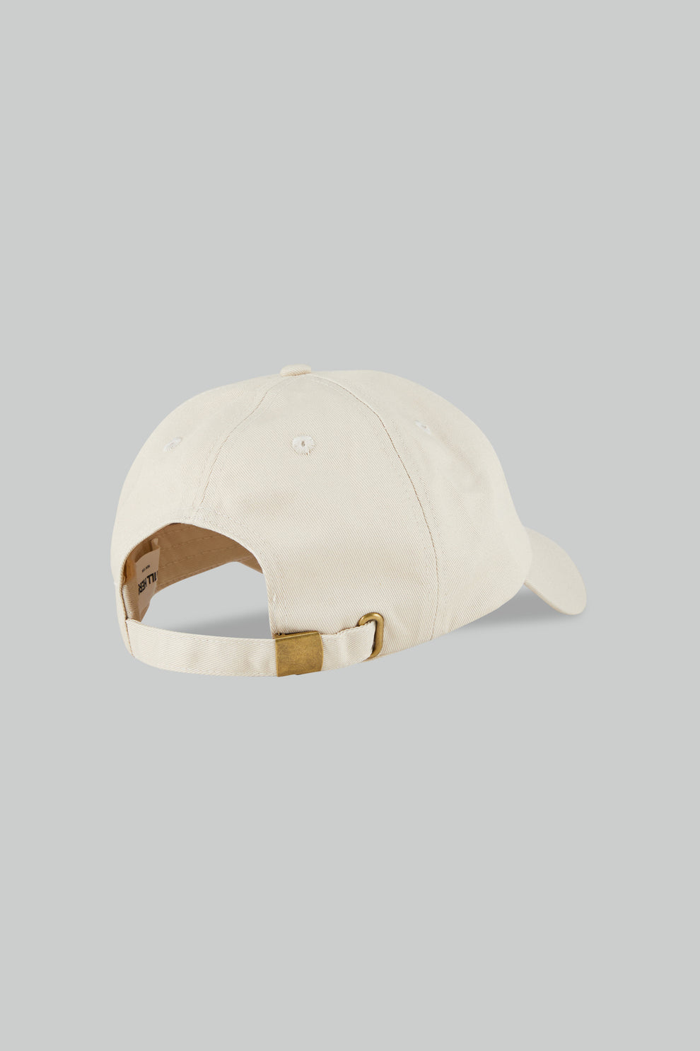 Beige cap with brown leather strap on a gray background