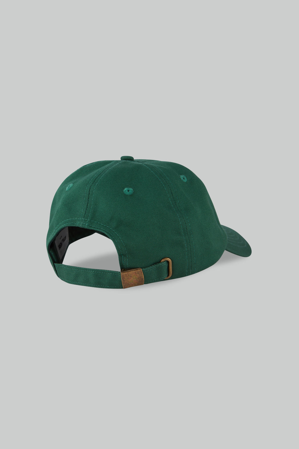 Green cap with a brown patch on a gray background