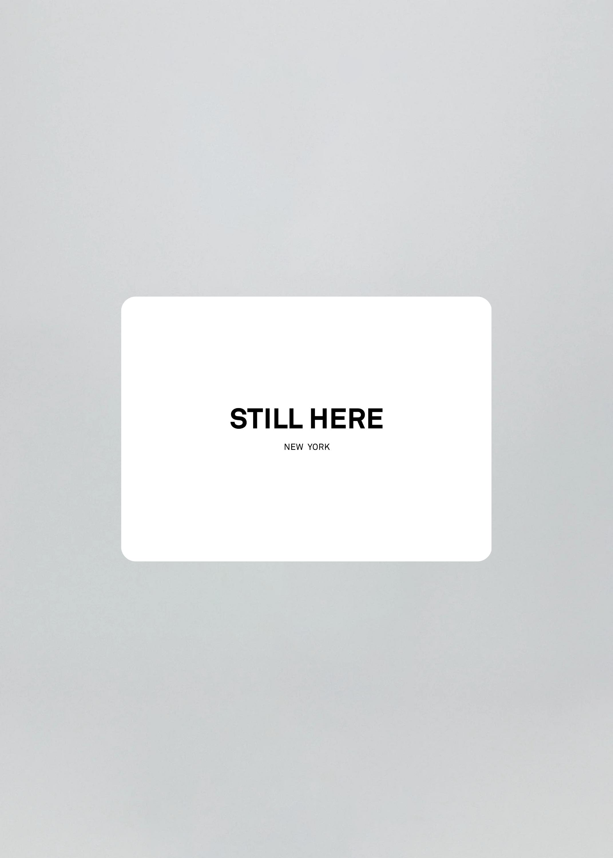 White card with 'STILL HERE NEW YORK' text on a gray background