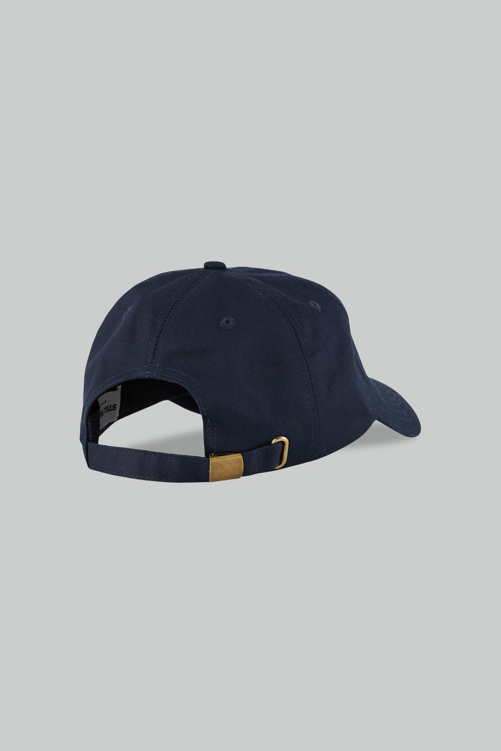 Navy blue cap with a brown buckle on a light gray background